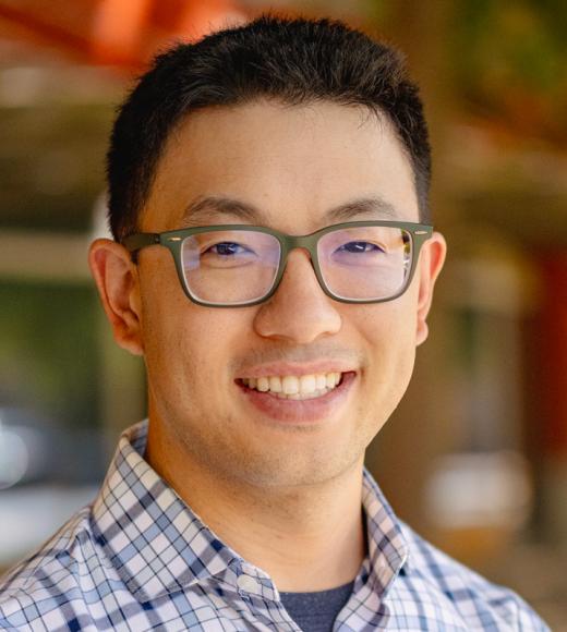 Photo of Alan Jenn in blue plaid shirt and glasses