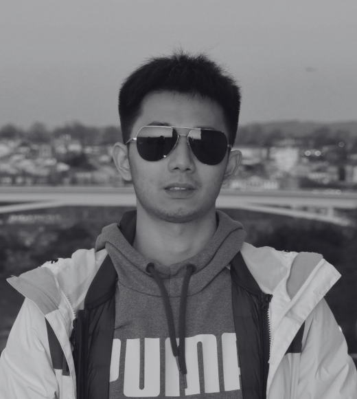 Black-and-white photograph of a man in sunglasses, hoodie 